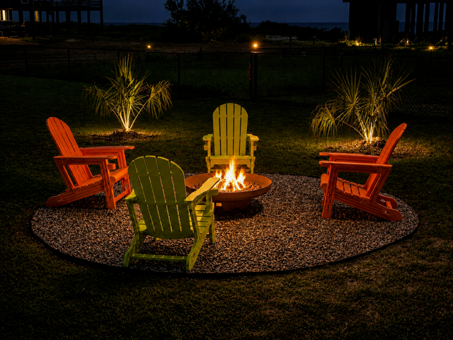 Fire pit and covered patio area with colorful chairs